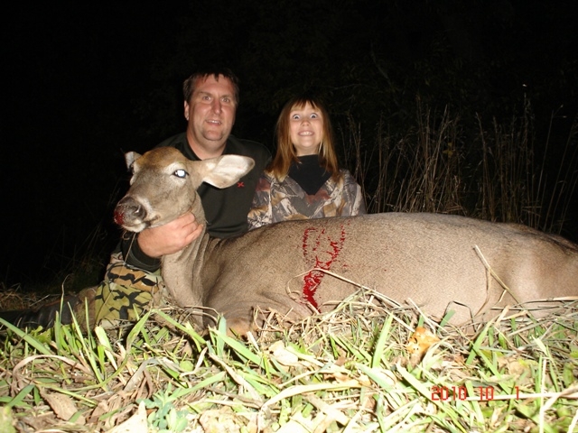 Photo of Joel and Shannon behind a harvested deer